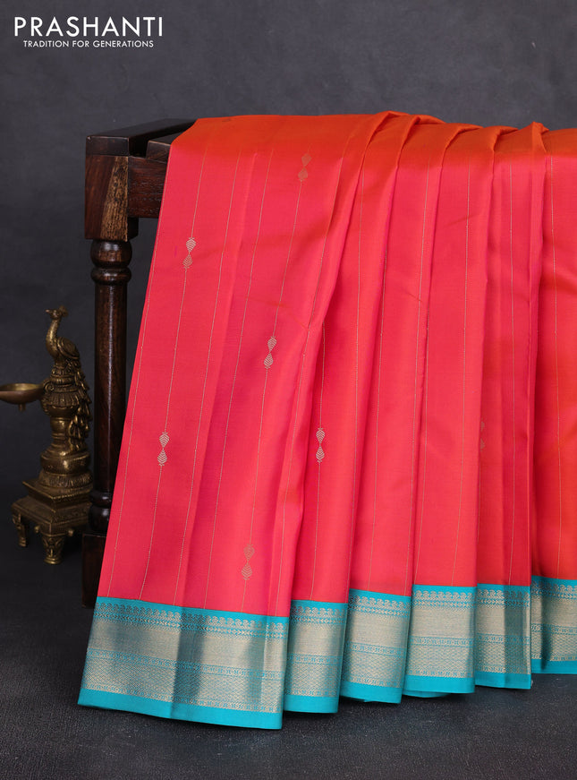 Pure kanchipuram silk saree dual shade of pinkish orange and teal blue with allover zari stripe pattern & buttas and zari woven korvai border