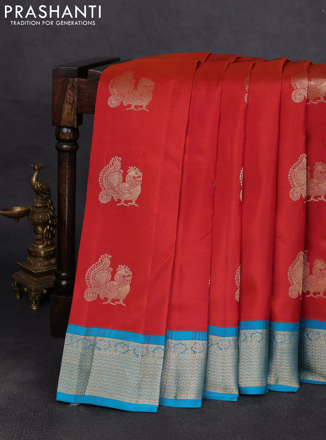 Pure kanchipuram silk saree rustic orange and cs blue with annam zari woven buttas and zari woven korvai border
