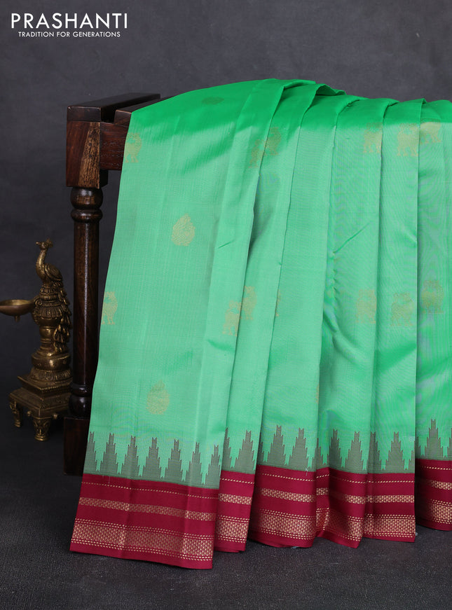 Pure kanchipuram silk saree teal green and wine shade with zari woven buttas and temple design rettapet zari woven korvai border