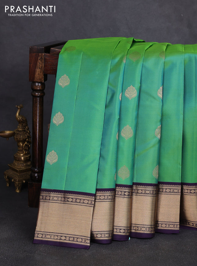 Pure kanchipuram silk saree dual shade of bluish green and violet with zari woven buttas and zari woven korvai border