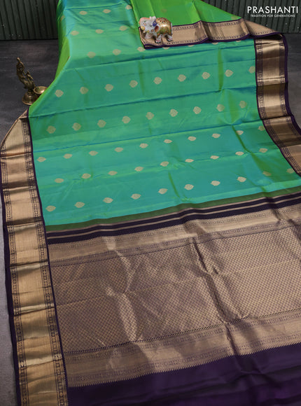 Pure kanchipuram silk saree dual shade of bluish green and violet with zari woven buttas and zari woven korvai border