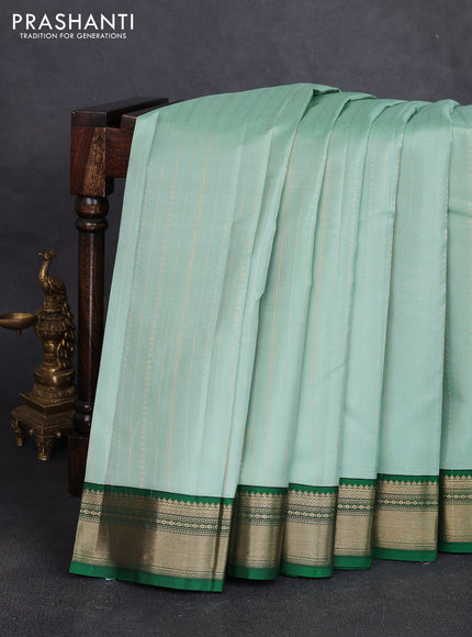 Pure kanchipuram silk saree pastel green and green with allover zari stripe pattern & buttas and zari woven korvai border