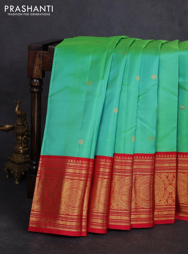 Pure kanchipuram silk saree dual shade of teal green and red with zari woven buttas and long zari woven korvai border