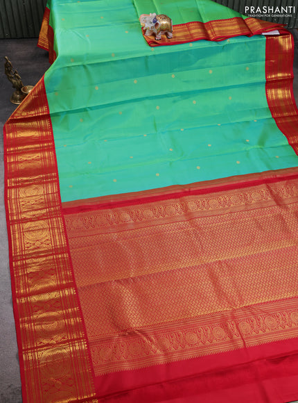 Pure kanchipuram silk saree dual shade of teal green and red with zari woven buttas and long zari woven korvai border