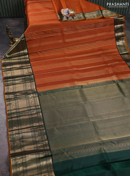 Pure kanchipuram silk saree orange and bottle green with allover zari stripe pattern and long zari woven korvai border