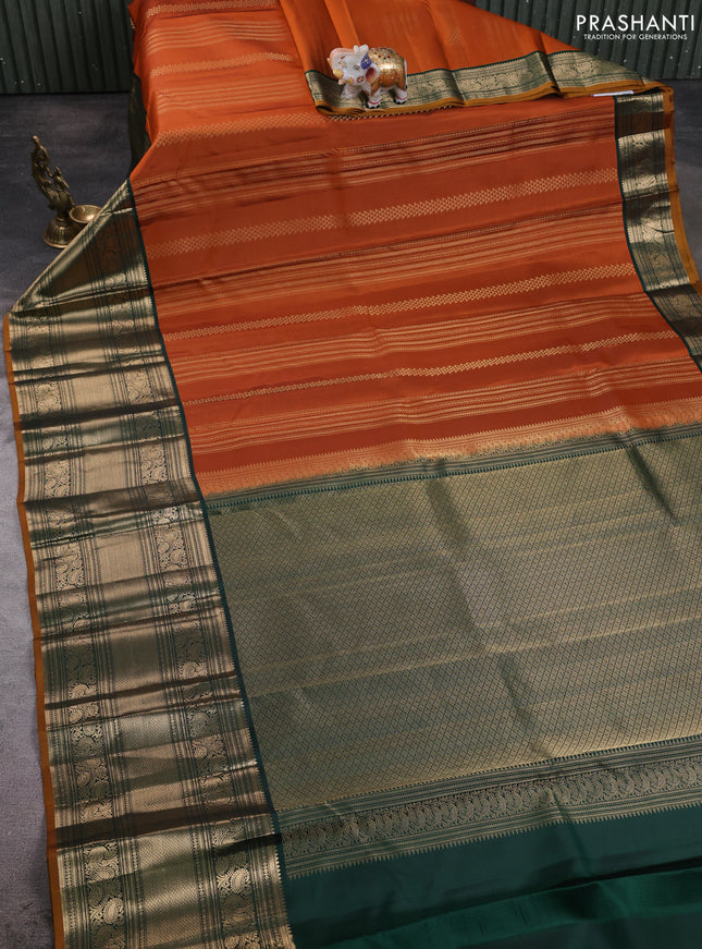 Pure kanchipuram silk saree orange and bottle green with allover zari stripe pattern and long zari woven korvai border
