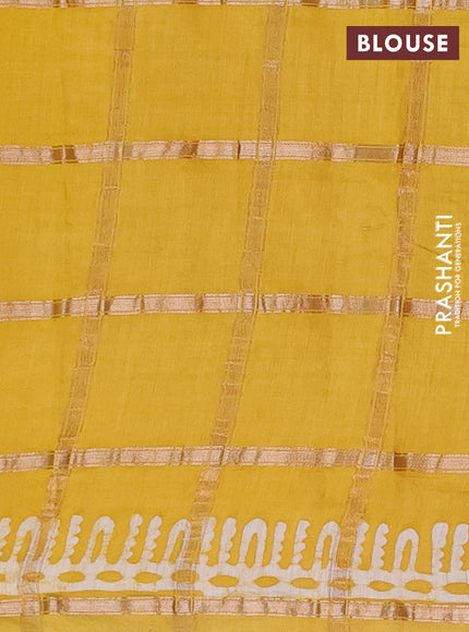 Semi chanderi saree yellow and off white with allover zari checks & batik prints and batik printed border
