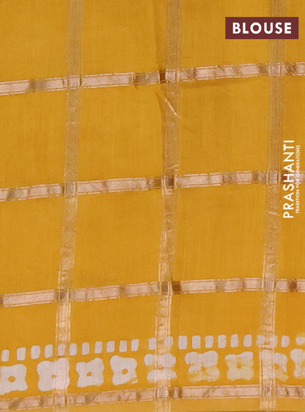 Semi chanderi saree mustard yellow with allover zari checks & batik prints in borderless style