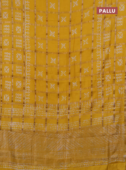 Semi chanderi saree yellow with allover zari checks & batik prints in borderless style