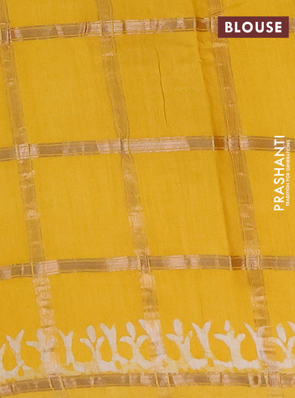 Semi chanderi saree yellow with allover zari checks & batik prints in borderless style