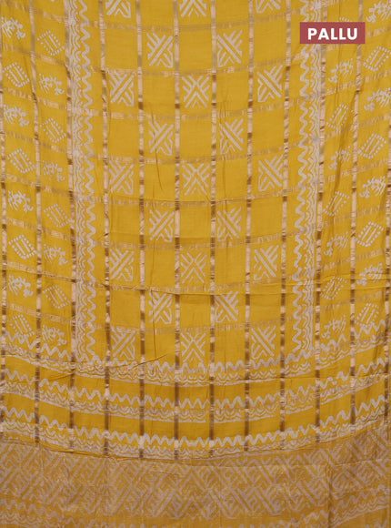 Semi chanderi saree yellow with allover zari checks & batik prints in borderless style