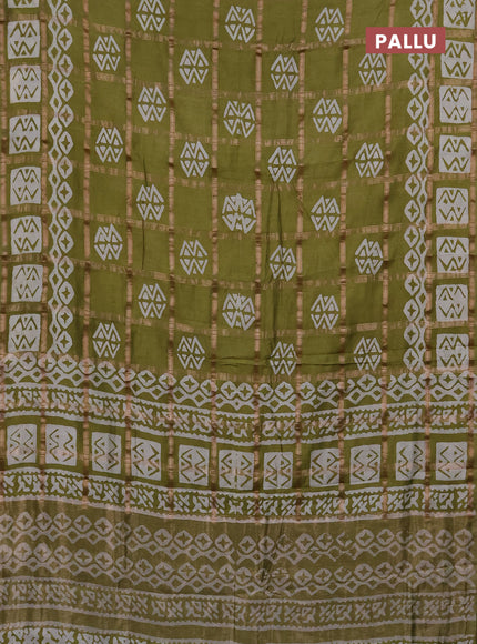 Semi chanderi saree mehendi green with allover zari checks & batik prints in borderless style