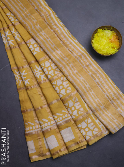 Semi chanderi saree mustard with allover zari checks & batik prints in borderless style
