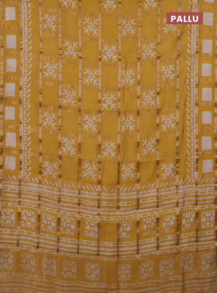 Semi chanderi saree mustard with allover zari checks & batik prints in borderless style
