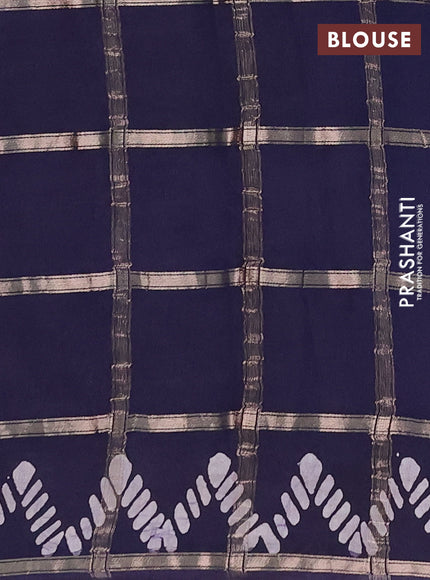 Semi chanderi saree navy blue with allover zari checks & batik prints in borderless style