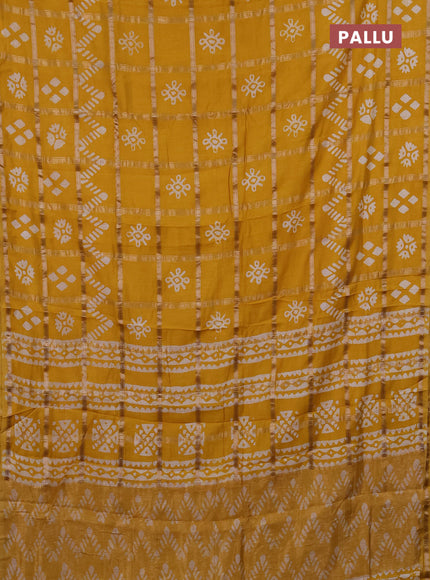 Semi chanderi saree mustard with allover zari checks & batik prints in borderless style