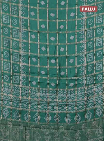 Semi chanderi saree green shade with allover zari checks & batik prints in borderless style