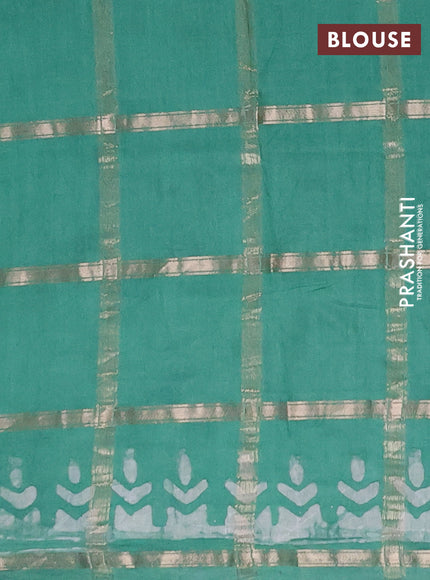 Semi chanderi saree green shade with allover zari checks & batik prints in borderless style