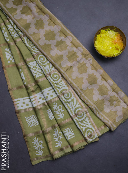 Semi chanderi saree mehendi green and off white with allover zari checks & batik prints and batik printed border