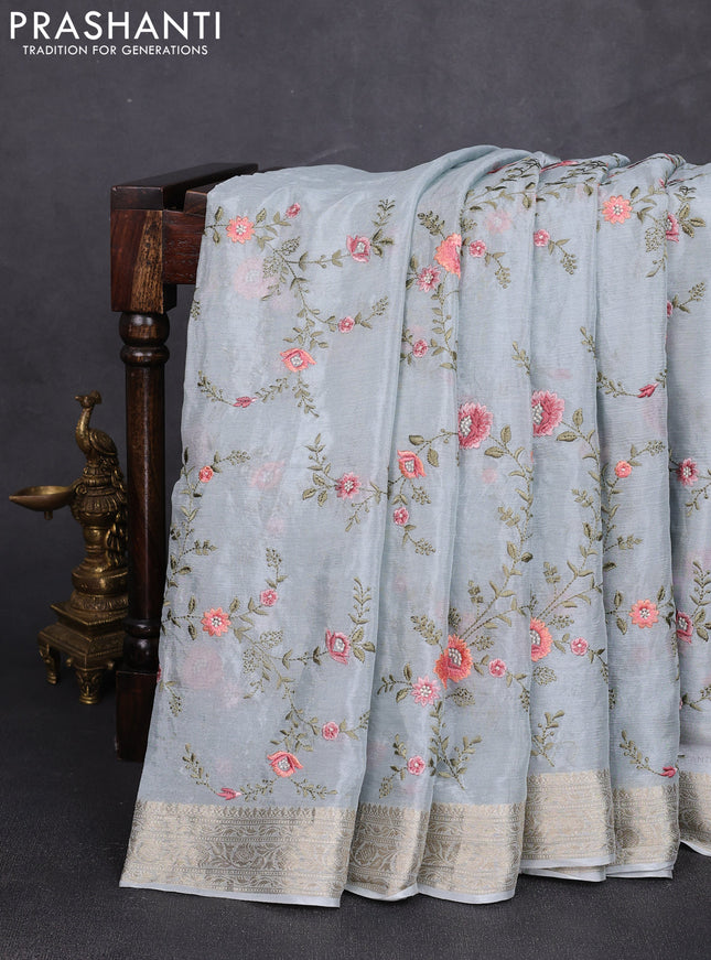 Chiffon saree pastel blue with allover floral embroidery work and zari woven border
