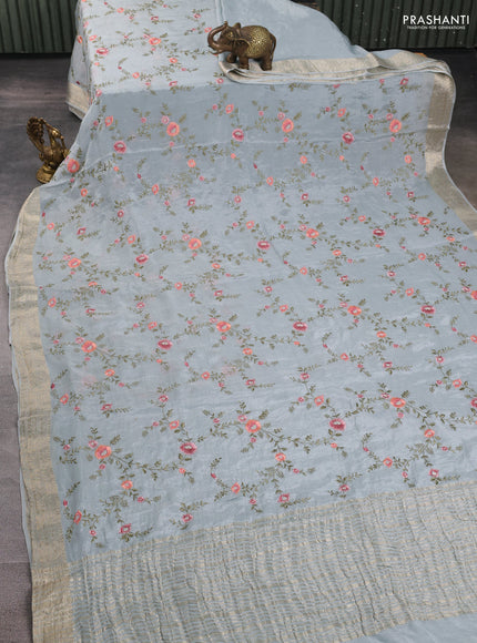 Chiffon saree pastel blue with allover floral embroidery work and zari woven border