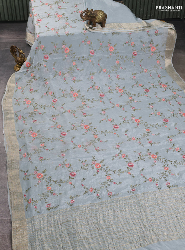 Chiffon saree pastel blue with allover floral embroidery work and zari woven border