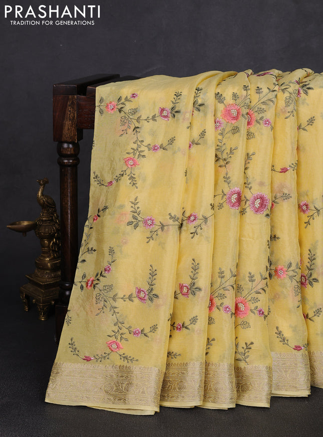 Chiffon saree yellow with allover floral embroidery work and zari woven border