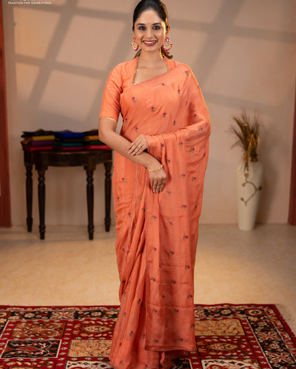 Chiffon saree peach shade with allover floral embroidery buttas and lace work border