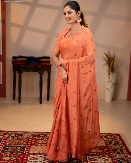 Chiffon saree peach shade with allover floral embroidery buttas and lace work border