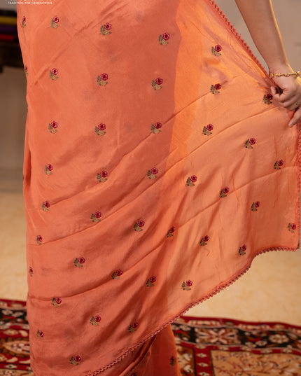 Chiffon saree peach shade with allover floral embroidery buttas and lace work border