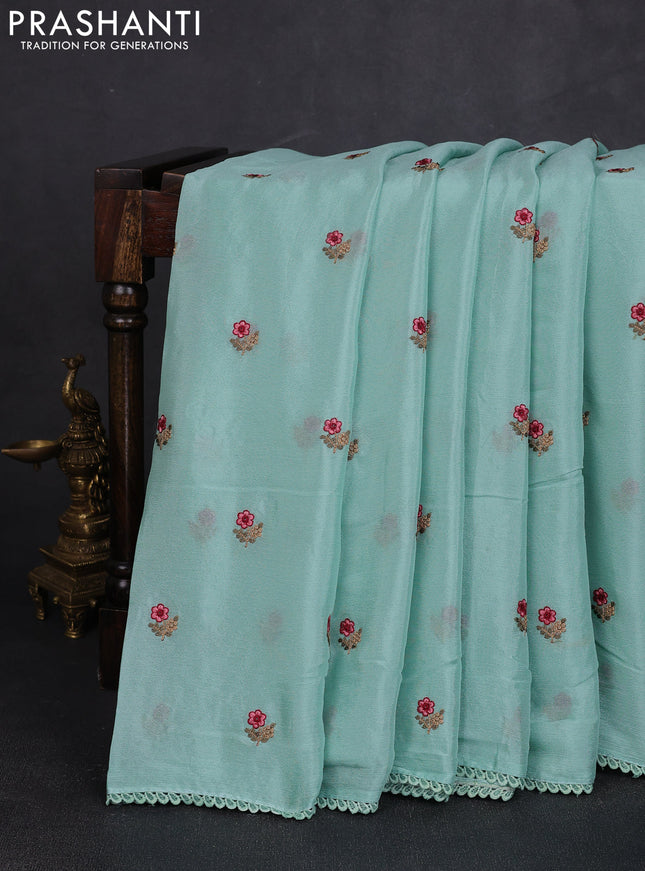 Chiffon saree teal shade with allover floral embroidery buttas and lace work border
