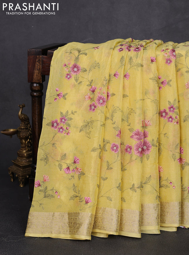 Chiffon saree pale yellow with allover floral embroidery work and zari woven border