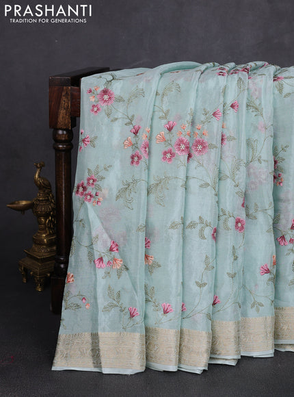 Chiffon saree teal shade with allover floral embroidery work and zari woven border