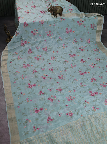 Chiffon saree teal shade with allover floral embroidery work and zari woven border