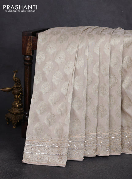 Banarasi silk saree beige shade with allover zari woven buttas and zardosi work pallu & border