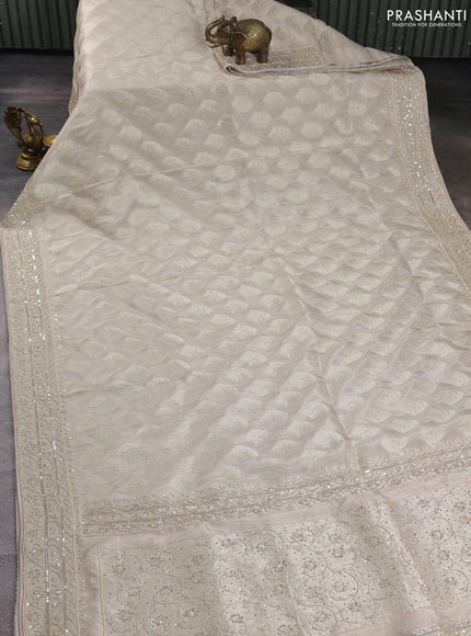 Banarasi silk saree beige shade with allover zari woven buttas and zardosi work pallu & border