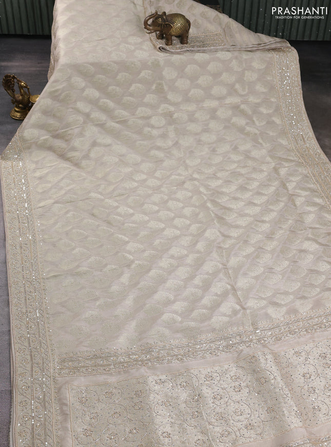 Banarasi silk saree beige shade with allover zari woven buttas and zardosi work pallu & border