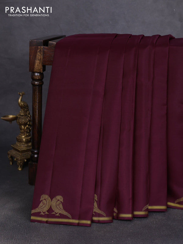 Pure kanchipuram silk saree wine shade with plain body and zari woven parrot butta border