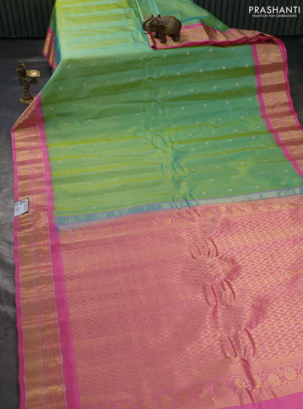 Pure gadwal silk saree dual shade of bluish yellow and peach pink with allover zari woven buttas and temple design zari woven border