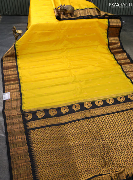 Pure gadwal silk saree yellow and black with allover zari woven buttas and temple design zari woven border