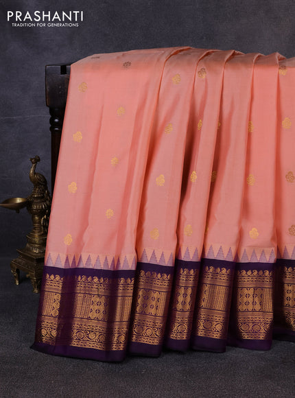 Pure gadwal silk saree peach shade and violet with allover zari woven buttas and temple design zari woven border