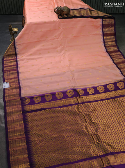 Pure gadwal silk saree peach shade and violet with allover zari woven buttas and temple design zari woven border