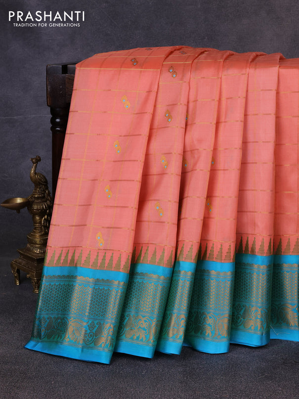 Pure gadwal silk saree peach orange and teal blue with allover zari checks & buttas and temple design zari woven border
