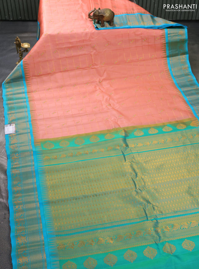 Pure gadwal silk saree peach orange and teal blue with allover zari checks & buttas and temple design zari woven border