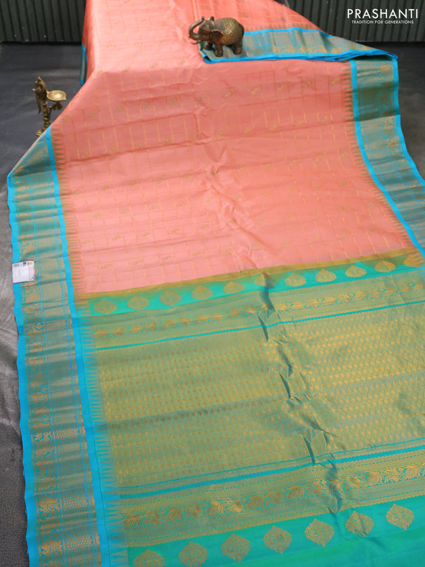 Pure gadwal silk saree peach orange and teal blue with allover zari checks & buttas and temple design zari woven border