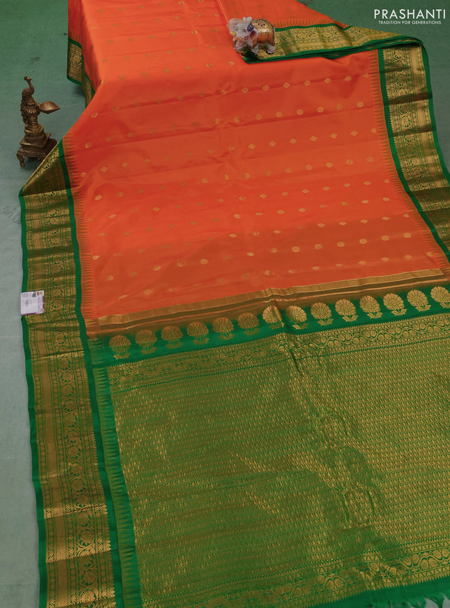 Pure gadwal silk saree orange and green with allover zari woven buttas and temple design zari woven border