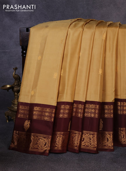 Pure gadwal silk saree sandal and coffee brown with allover zari woven buttas and rettapet zari woven korvai butta border