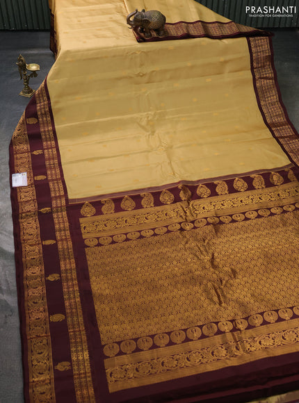 Pure gadwal silk saree sandal and coffee brown with allover zari woven buttas and rettapet zari woven korvai butta border