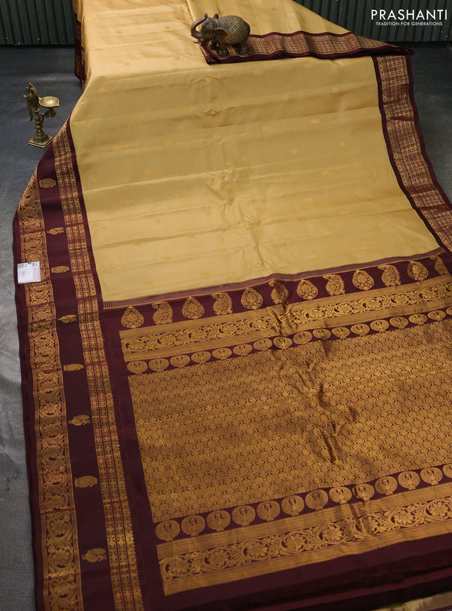 Pure gadwal silk saree sandal and coffee brown with allover zari woven buttas and rettapet zari woven korvai butta border