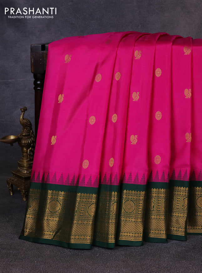 Pure gadwal silk saree dark pink and bottle green with allover zari woven buttas and temple design zari woven border